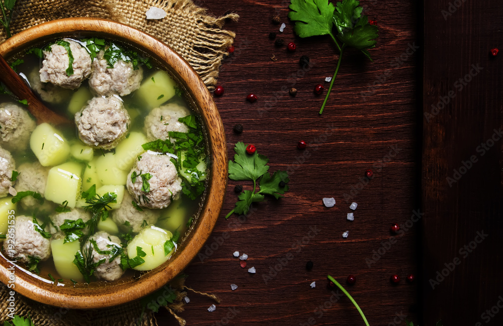 Homemade soup with meatballs and potatoes, rustic style, top view Homemade soup with meatballs and potatoes, rustic style, top view