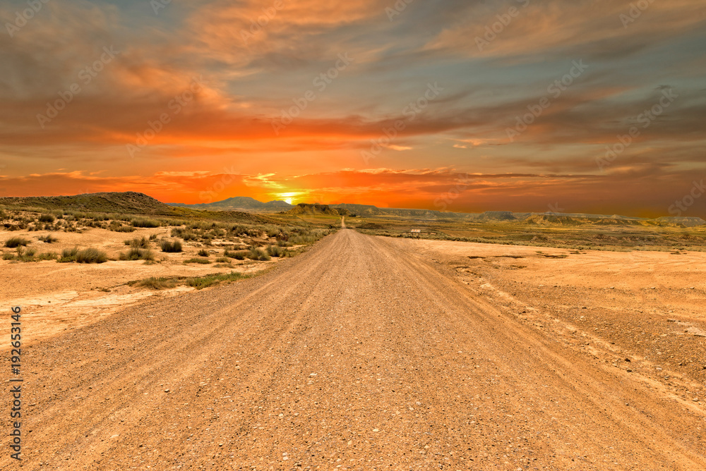 Highway through the desert on a sunset