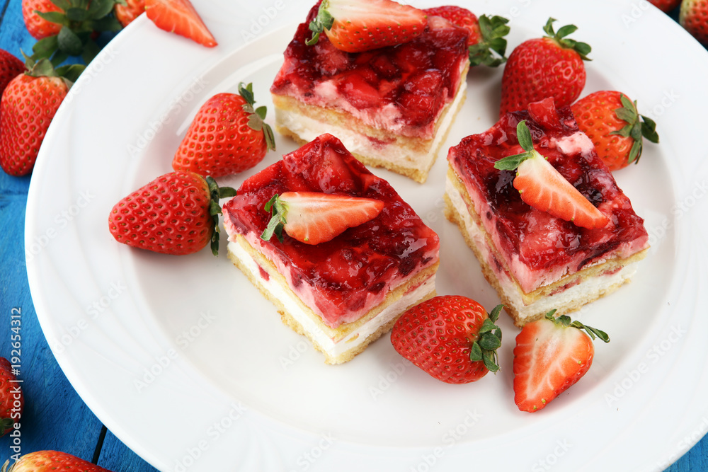 strawberry cake with fresh strawberries and whipped cream.