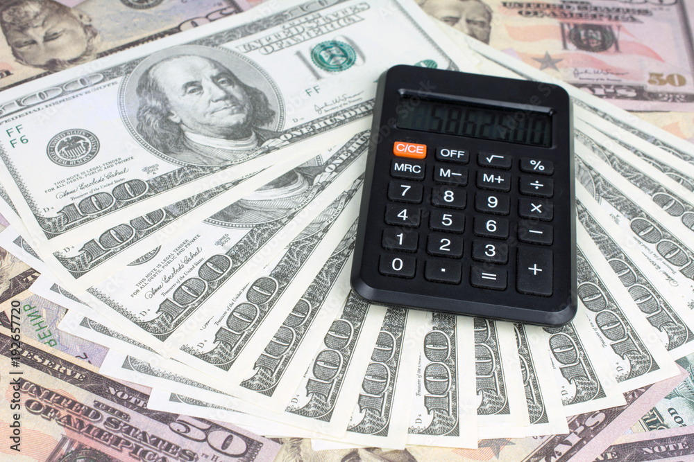 calculator green notebook with dollar bills on the background of money borrowed money concept calculator green notebook with dollar bills on the background of money borrowed money concept