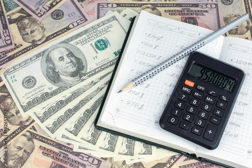 calculator green notebook with dollar bills on the background of money pension scheme concept calculator green notebook with dollar bills on the background of money pension scheme concept
