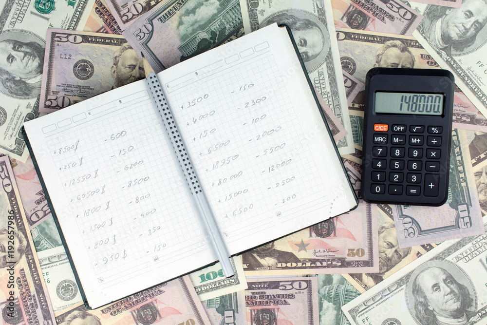 Obraz premium Money made on the stock exchange, dollars, green notepad, calculator, gray pencil