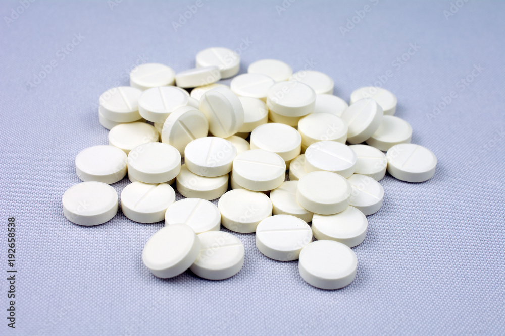 white round tablets, copy space, selective focus , blurred neutral background, white round tablets, copy space, selective focus , blurred neutral background,