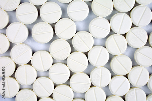 white round tablets, copy space, selective focus , blurred neutral background,