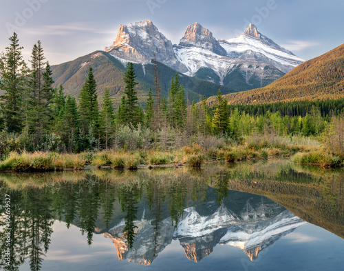 Sunrise of the Three Sisters and the Bow River from Canmore near Banff National Park photo
