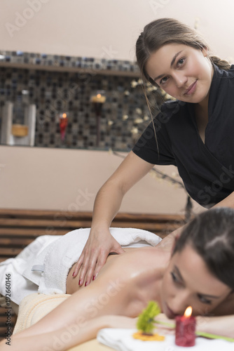 Spa woman. Female enjoying relaxing back massage in cosmetology spa centre. Body care, skin care, wellness, wellbeing, beauty treatment concept.