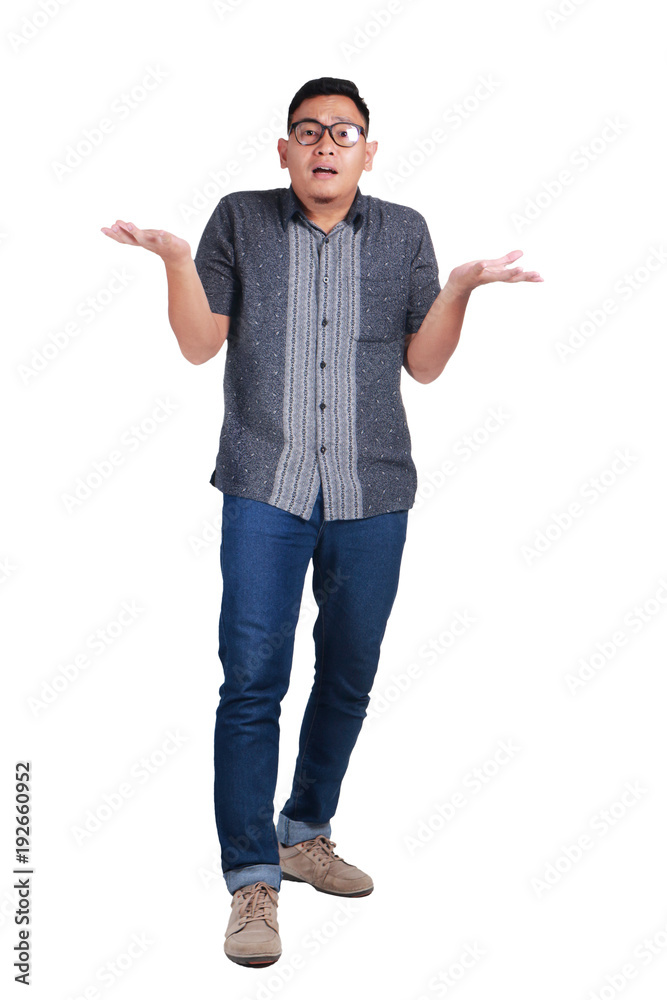 Young Asian Man Standing Wearing Batik Shirt, Shrug Gesture Young Asian Man Standing Wearing Batik Shirt, Shrug Gesture