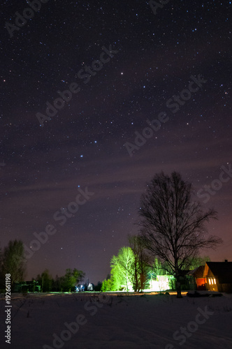 The great bear constellation above the village. Winter, starry night.