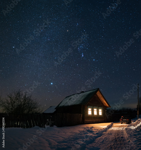 House in the Russian village of winter and frosty night. Starry the sky over head. The constellation of Orion. © dmitriydanilov62