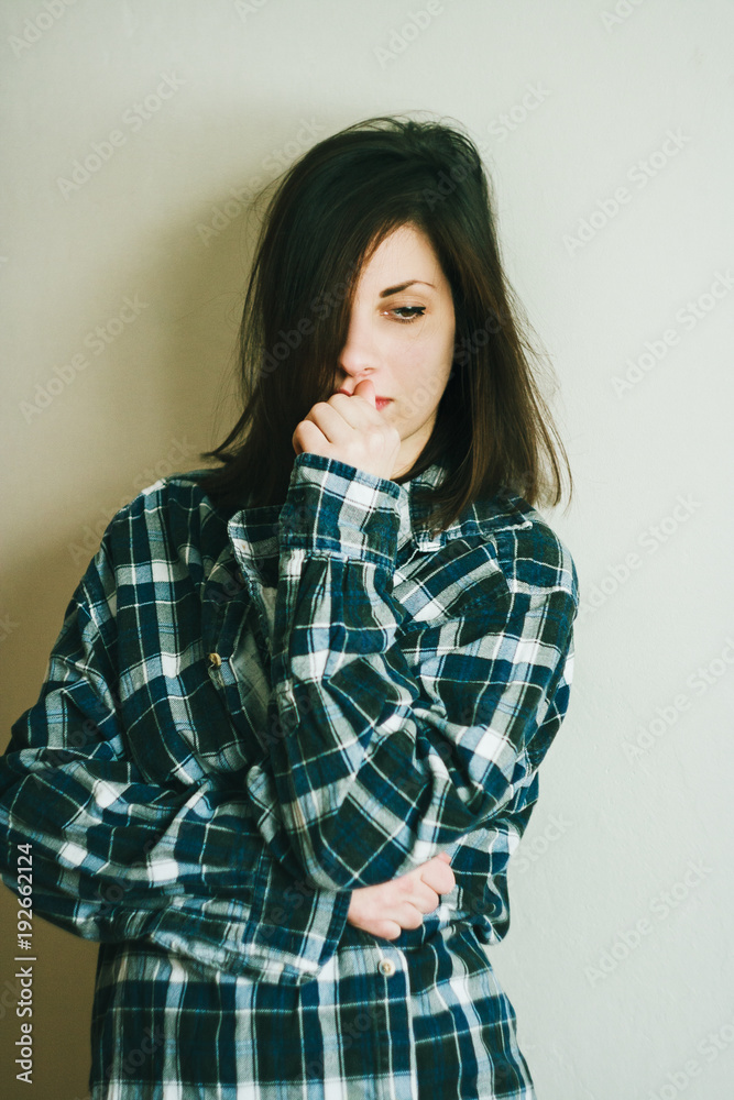 Close up portrait of pretty confident thoughtful girl, holding hand near the face, looking seriously up, standing over white background Close up portrait of pretty confident thoughtful girl, holding hand near the face, looking seriously up, standing over white background