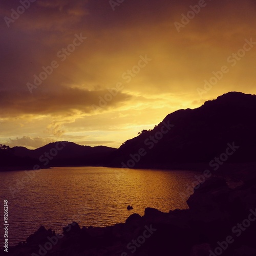 Burning sunset over a mountain lake in Corsica France