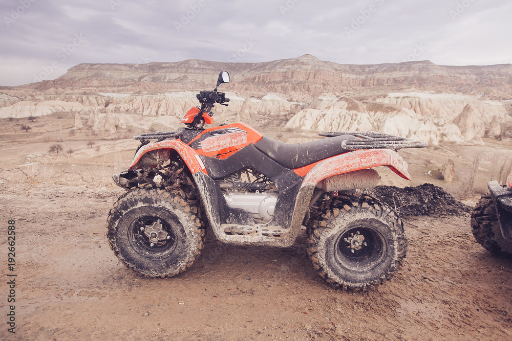 ATV Quad Bike in front of mountains landscape ATV Quad Bike in front of mountains landscape