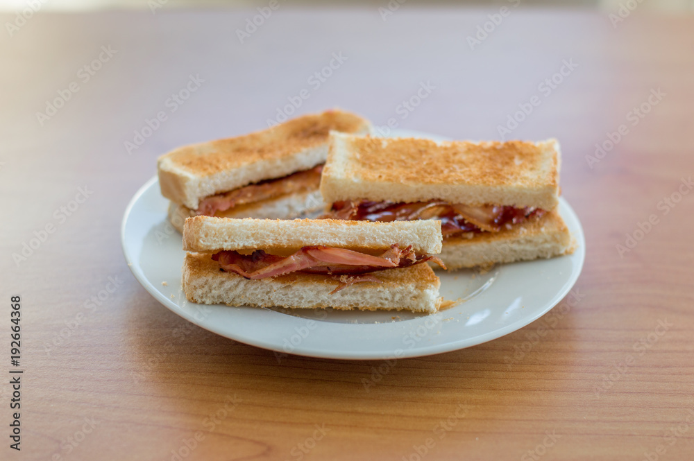 Three slice of toast with bacon.