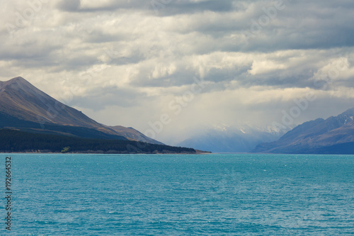 Mountains with heavy clouds and lake Pukaki on the foreground, New Zealand, South island, Canterbury