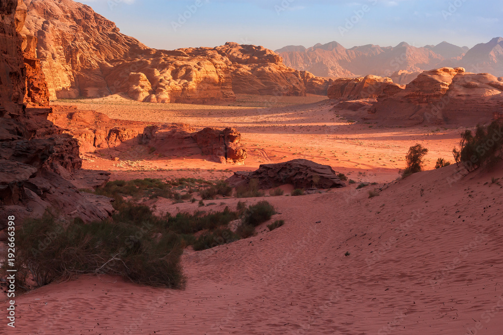 Fototapeta premium Red mountains of the canyon of Wadi Rum desert in Jordan. Wadi Rum also known as The Valley of the Moon is a valley cut into the sandstone and granite rock in southern Jordan to the east of Aqaba.
