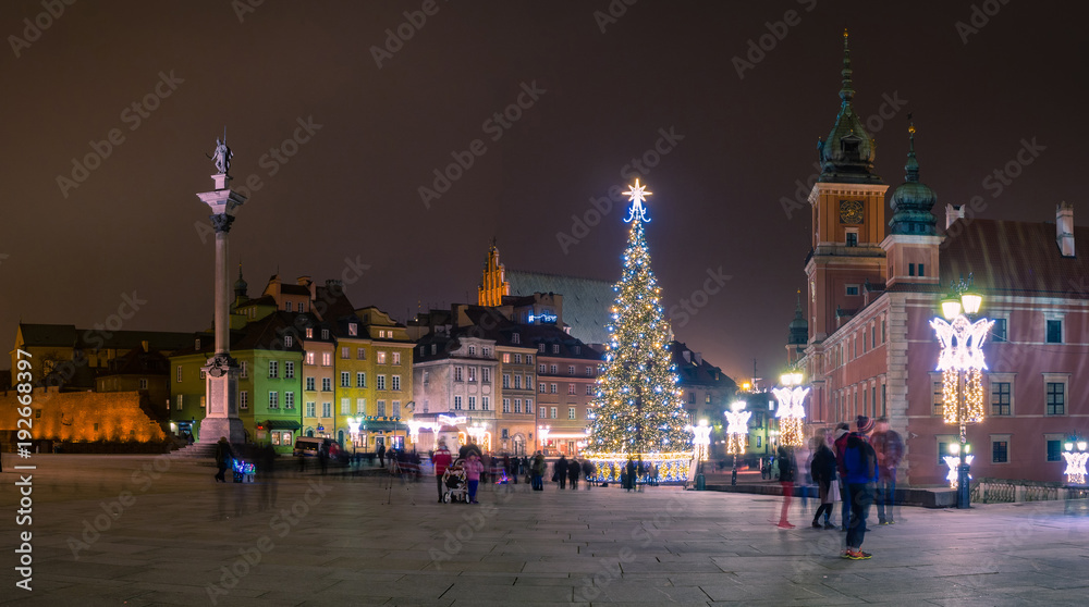 A view of the castle square in Warsaw with the Zygmunt's Column in winter, with Christmas lighting and a Christmas tree