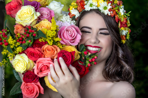 Beautiful woman in wreath of flowers