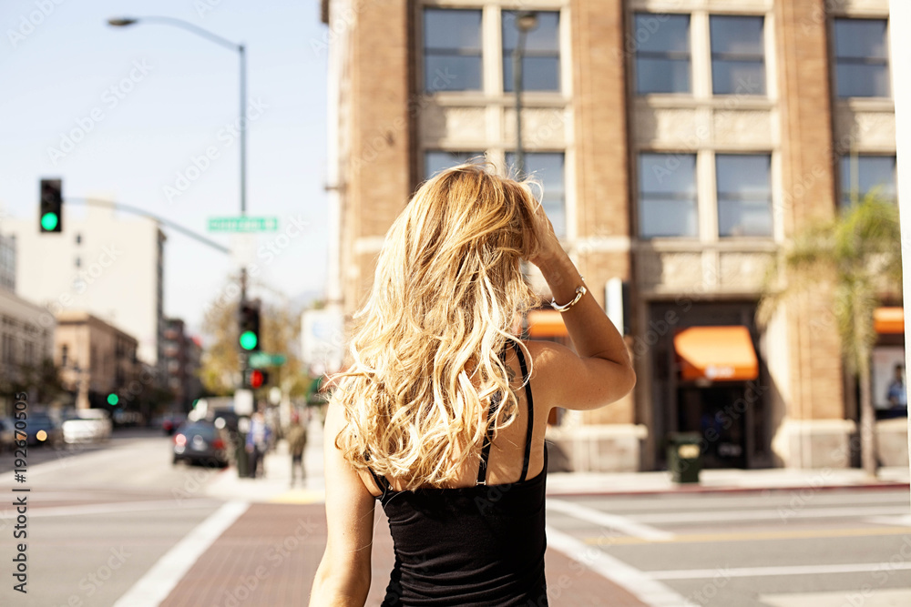 Blonde model from the back on the street Blonde model from the back on the street