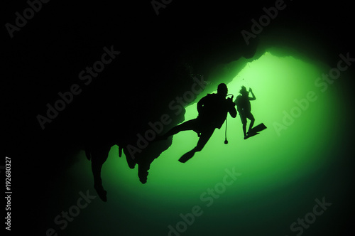 Silhouetted Underwater Diver in Cenote of Mexico