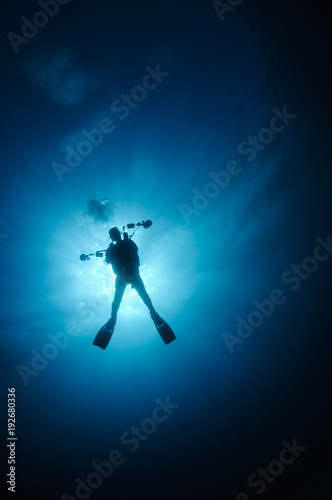 Silhouette of Underwater Photographer in Clear Blue Water