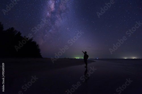 milkyway galaxy rise above lone tree at Kudat  Sabah Malaysia. Image contain soft focus  blur and noise due to long expose and high iso. Long expose and high iso setting need in night photo. 