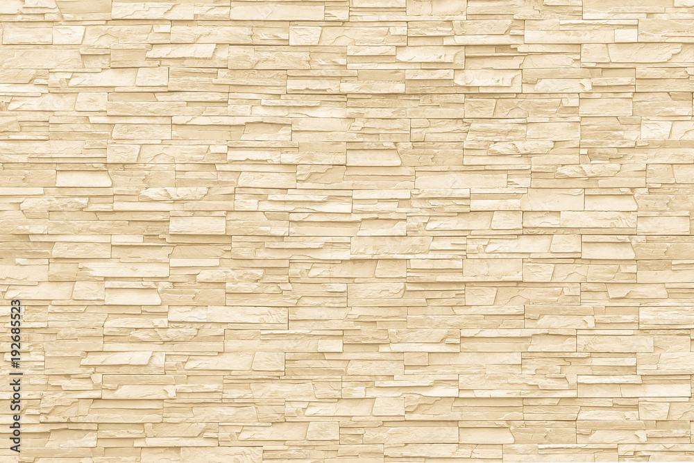 Rock stone brick tile wall aged texture detailed pattern background in cream beige brown color Rock stone brick tile wall aged texture detailed pattern background in cream beige brown color