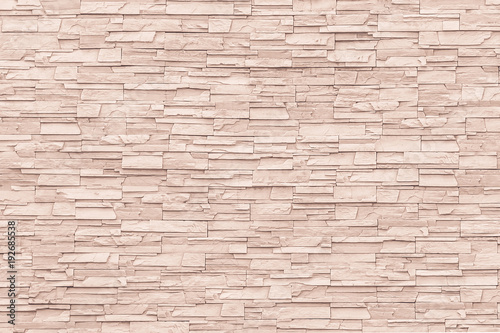 Rock stone brick tile wall aged texture detailed pattern background in cream beige brown color