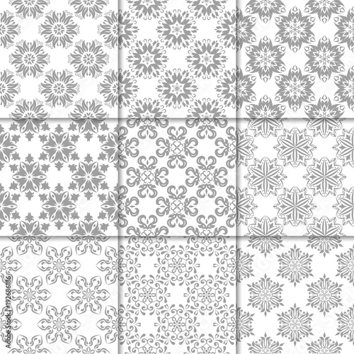Gray and white floral ornaments. Collection of seamless patterns