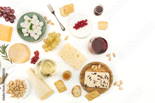 Various types of cheese with wine on a white background