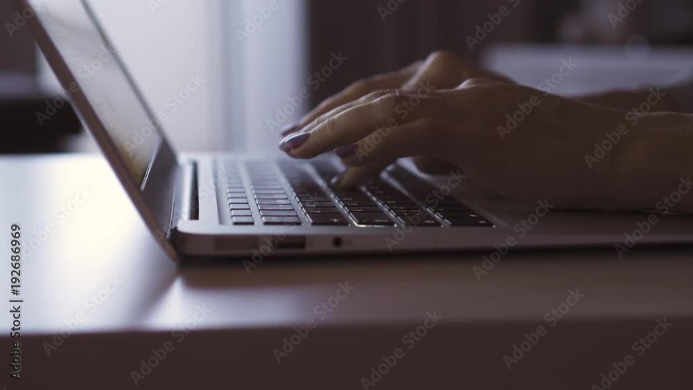 Female hands typing on a keyboard of laptop Female hands typing on a keyboard of laptop