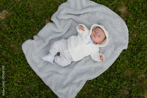 Cute baby lying on the pillow in the park