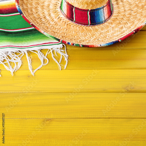 Cinco de mayo mexican background border with mexico sombrero straw hat blanket rug on old pine wood fiesta festival photo square format
