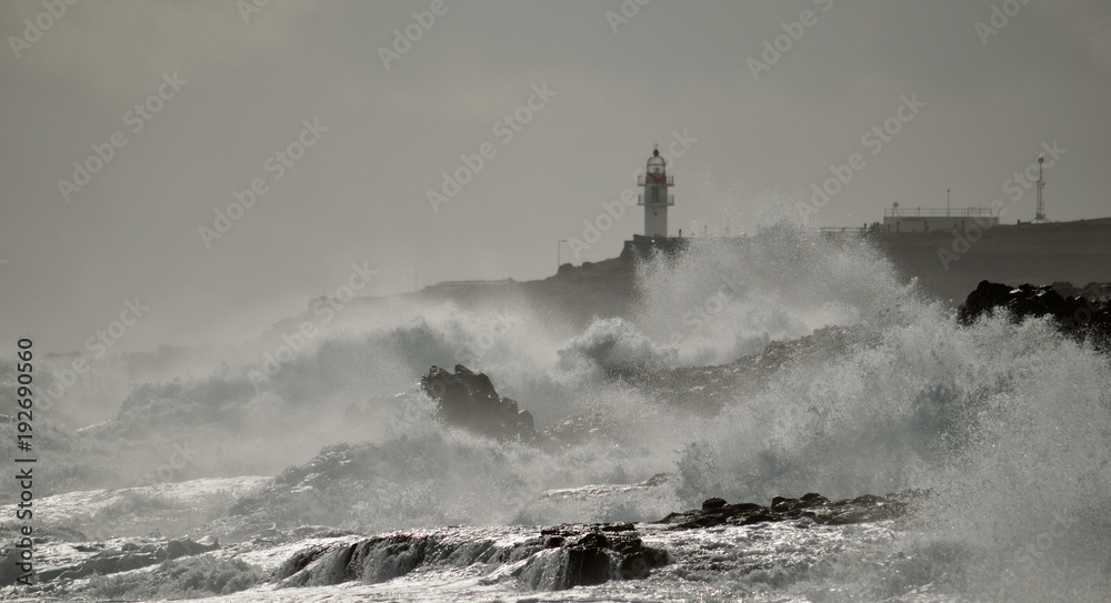 Coast with strong waves and lighthouse, Taliarte, Gran canaria, Canary islands
