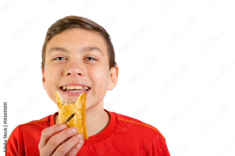 Young caucasian teenage boy with a sausage roll Young caucasian teenage boy with a sausage roll