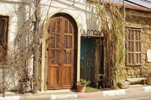 A Jewish public synagogue, in sought of Tel Aviv, kept like it was built in the 19th century. clear and sharp door and wooden window and small bench the picture looks like she took from the bible.