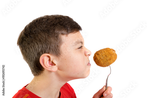Young caucasian teenage boy with a scotch egg
