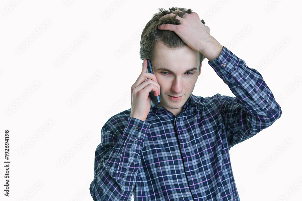 Closeup portrait of young, stressed business man, corporate employee, student talking on cell phone. Closeup portrait of young, stressed business man, corporate employee, student talking on cell phone.