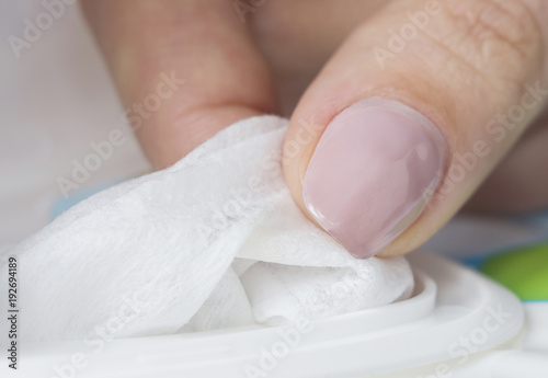 Baby wet wipes in a woman s hand. Close-up  selective focus.