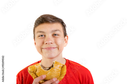 Εκτύπωση καμβά Young caucasian teenage boy eating a pasty