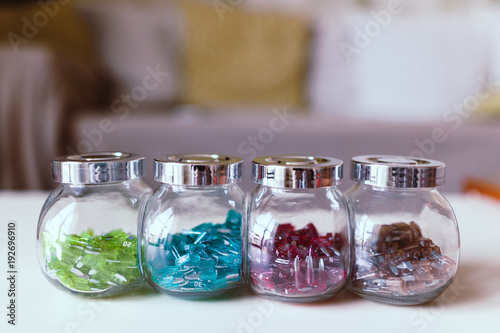 Car electric parts colorful mini fuses in kitchen spice rack on desk. Soft focus. photo