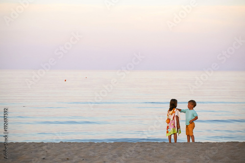 children boy and girl romance on the seashore colorful sunset. © makam1969