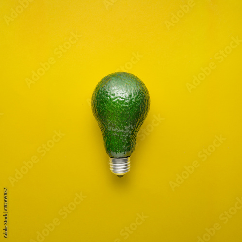 Fresh idea / Creative concept photo of avocado as electric bulb on yellow background.