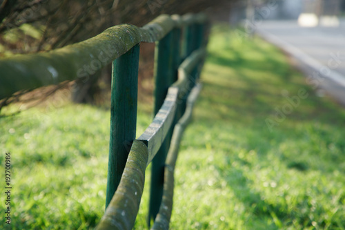 Fotografi Fence in the green field near the road, good for background
