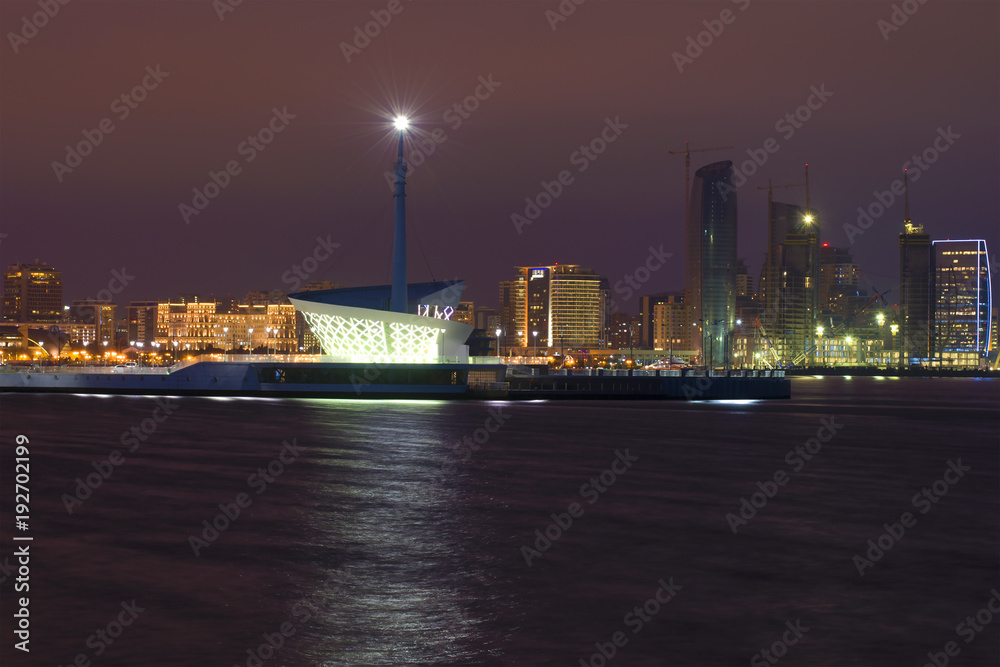A modern lighthouse in the Baku bay. Night Baku, Azerbaijan