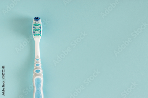 Toothbrush on bright blue background.