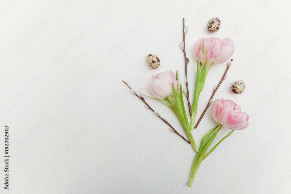Spring greeting card. Easter eggs with pink tulips and willow branch on white wooden background. Easter concept. Flat lay. Spring flowers tulips Spring greeting card. Easter eggs with pink tulips and willow branch on white wooden background. Easter concept. Flat lay. Spring flowers tulips