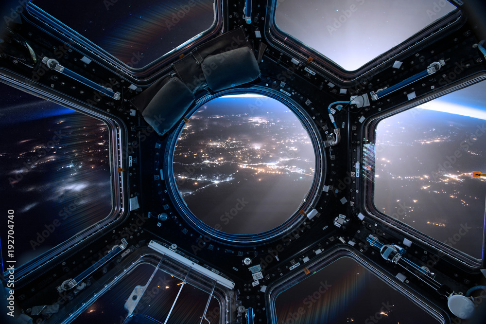View from a porthole of space station on the Earth background. Elements of this image furnished by NASA. View from a porthole of space station on the Earth background. Elements of this image furnished by NASA.
