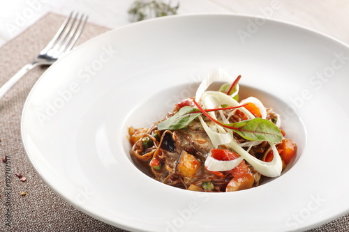 salad of stewed vegetables on a white wooden background
