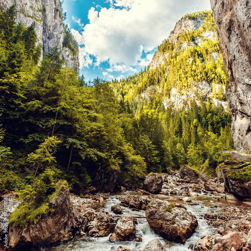 wonderful sunny mountain scenery. river in canyon in mountans gloving in sunlight. gorgeus unusual scene. Romania- Carpathian Mountains. Bicaz Canyon Cheile Bicazului . Beauty in the world. soft light photo