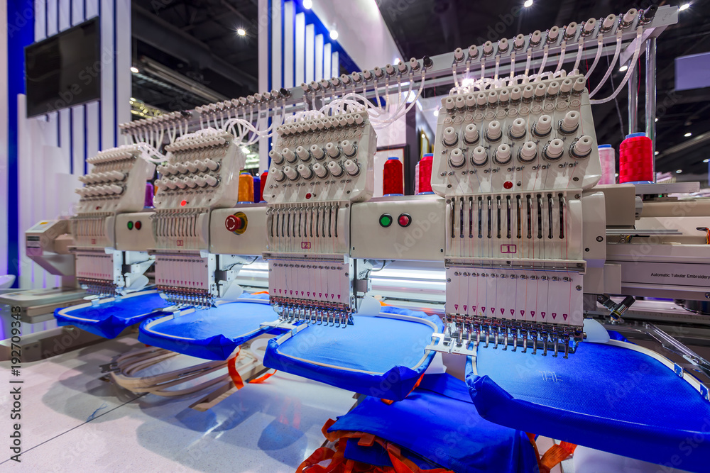 Textile - Professional and industrial embroidery machine. Machine  embroidery is an embroidery process whereby a sewing machine or embroidery  machine is used to create patterns on textiles. Photos | Adobe Stock